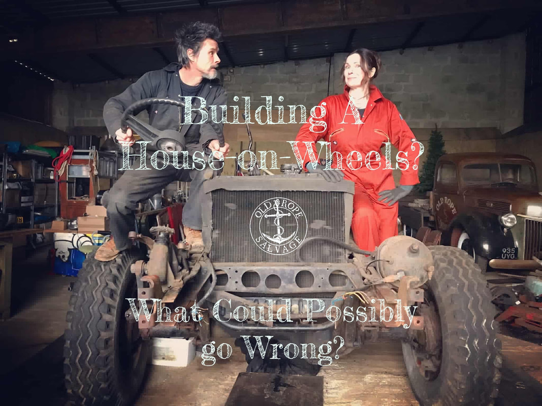 Couple sitting on top on a half dismantled Bedford truck