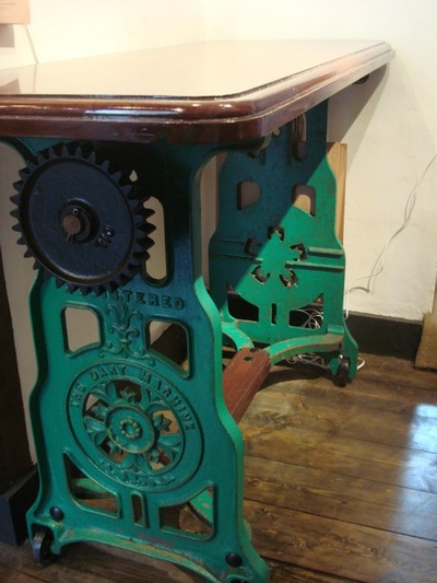 Victorian cast iron mangle was fitted with a reclaimed solid mahogany top to become an upcycled table.