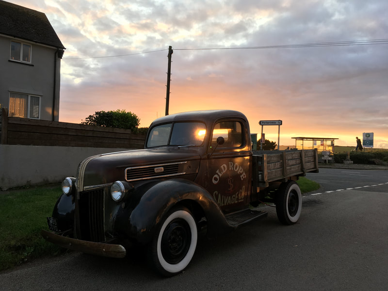1941 Old Rope Salvage Ford truck parked in a Cornish village at sunset