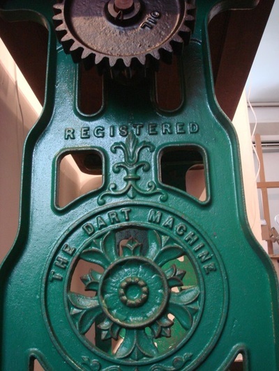 Victorian cast iron mangle was fitted with a reclaimed solid mahogany top to become an upcycled table