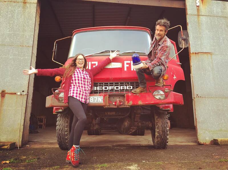 Man and woman with a vintage 1970s Bedford fire truck