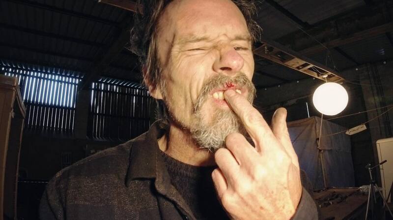 Man in workshop with a small facial injury