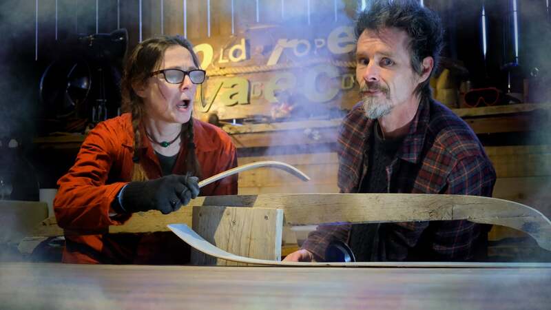 Man and woman steaming and bending a slice of thin oak