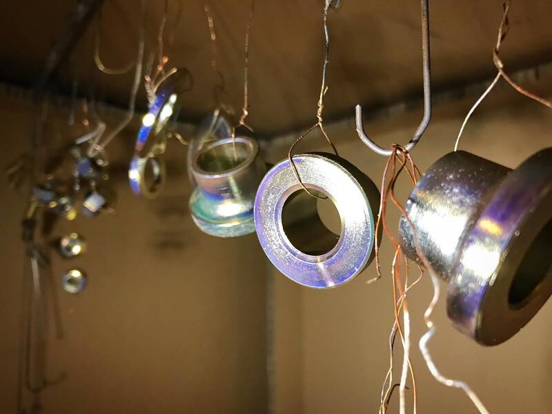 Electro plated nuts and bolts hanging up to dry