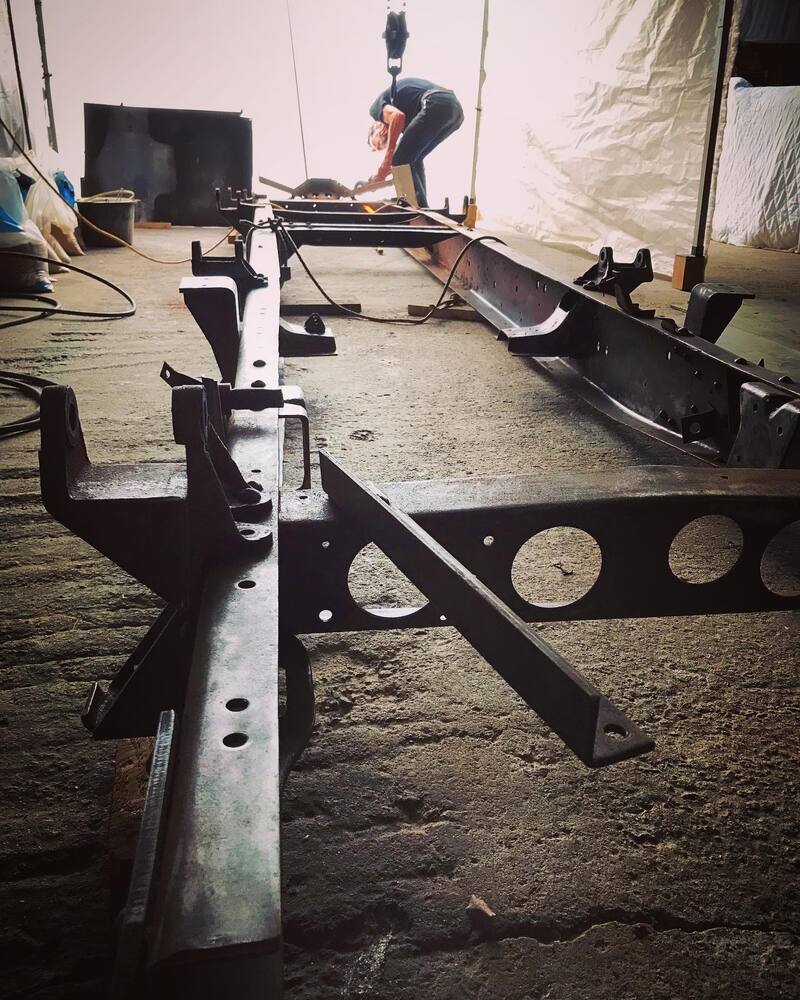 Man inspecting the chassis frame from a Bedford truck