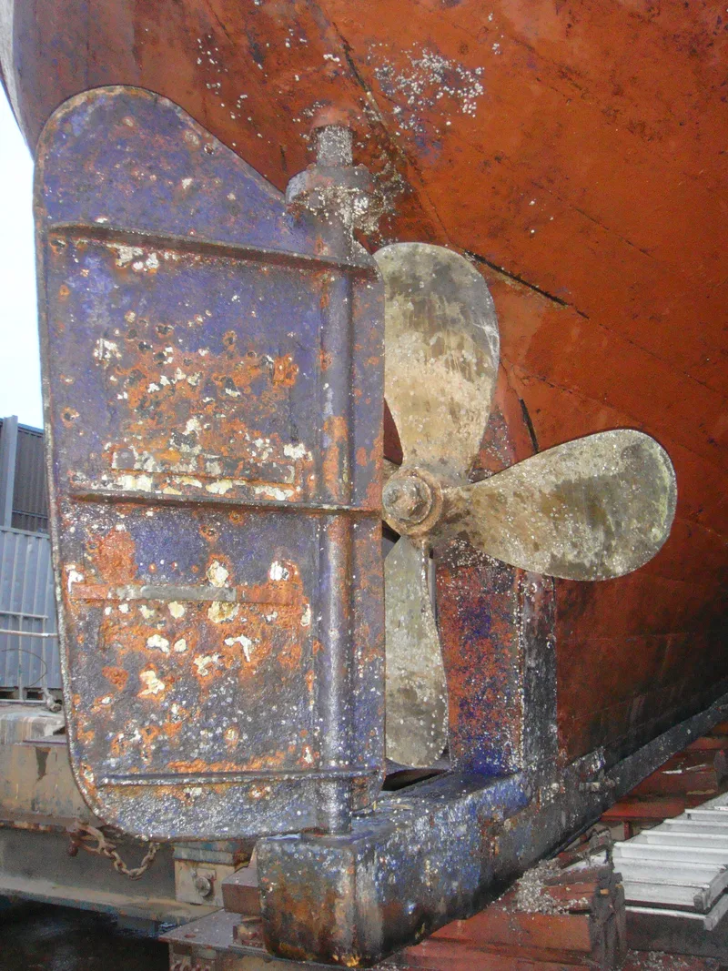 Close up view of the rudder and propeller of a large wooden fishing trawler