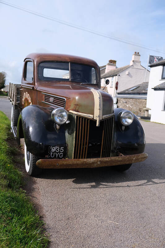1941 Old Rope Salvage Ford truck parked in Cornwall village