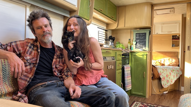 Man, woman and cat in a newly renovated caravan