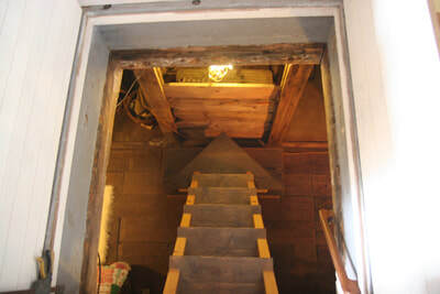 Hand crafted stairs going below decks in a houseboat interior