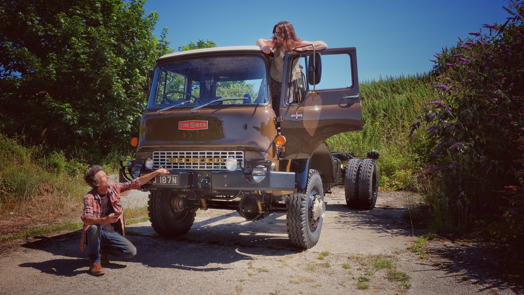 Man and woman pose with a restored 1975 Bedford truck called ‘The Siren’
