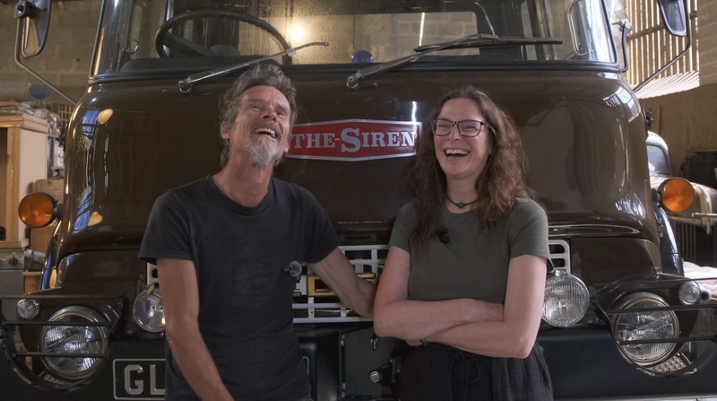 Man and woman standing in front of the Bedford truck named ‘The Siren’