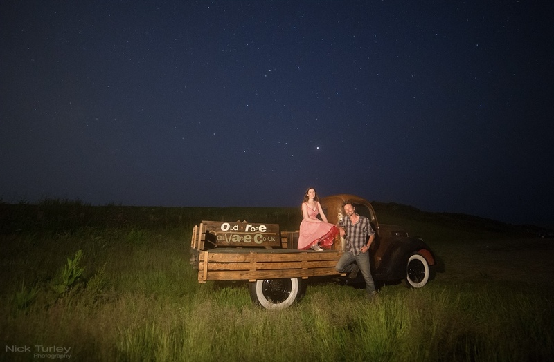 Man and woman with an Old Ford truck at night