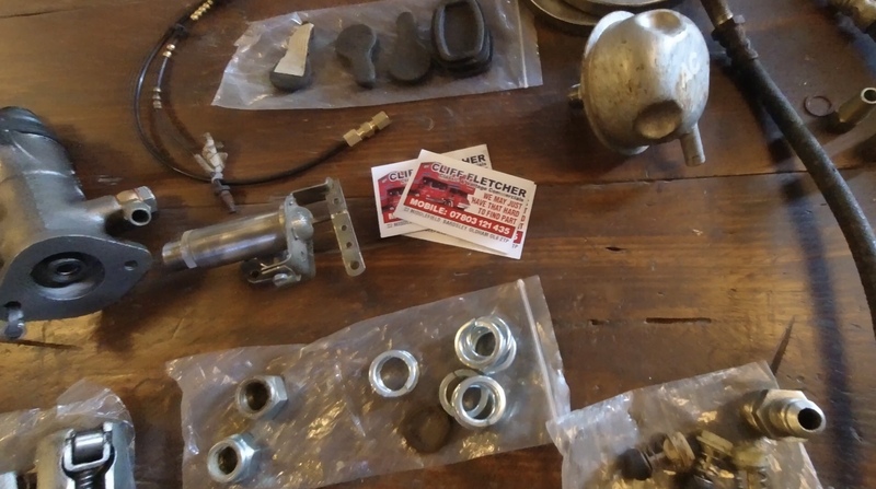 Some car parts on a wooden workbench