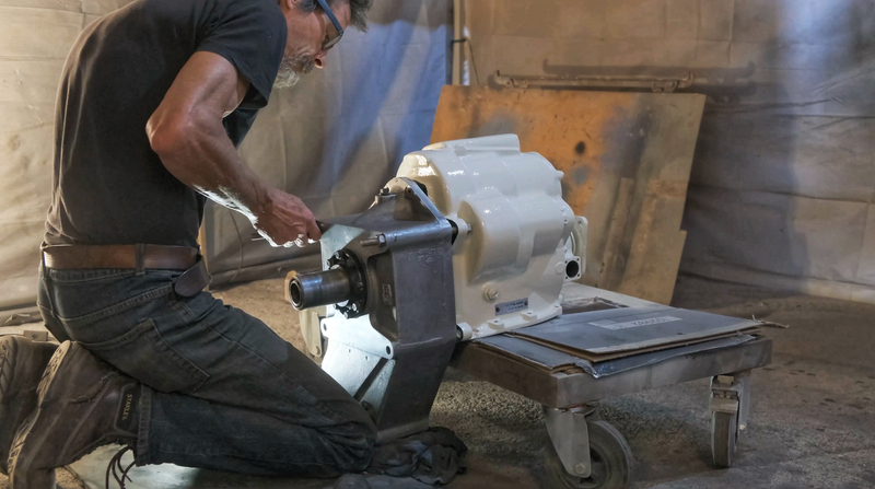 Man restoring the gearbox from a 1970s Bedford truck